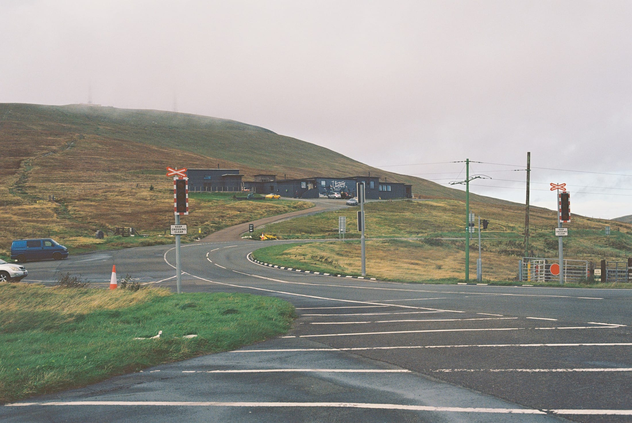 The Bungalow on the Mountain Road, where the Snaefell Mountain Railway crosses the road below the summit, on a grey day with a van parked at the side
